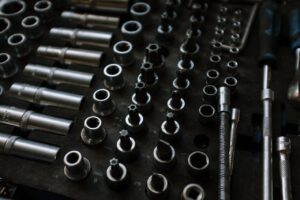 Close-up of assorted metal tools in an organized workshop setting, ideal for mechanical repairs.