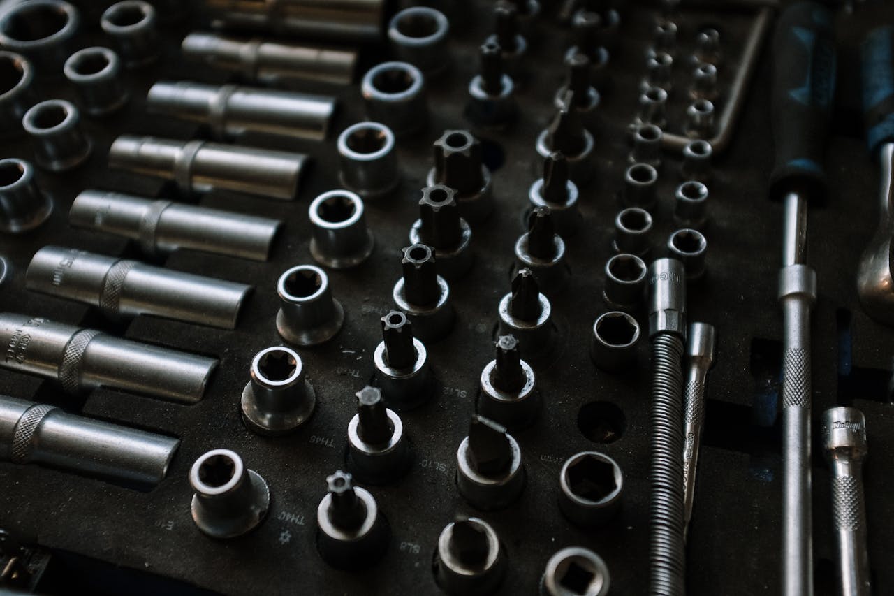 Close-up of assorted metal tools in an organized workshop setting, ideal for mechanical repairs.